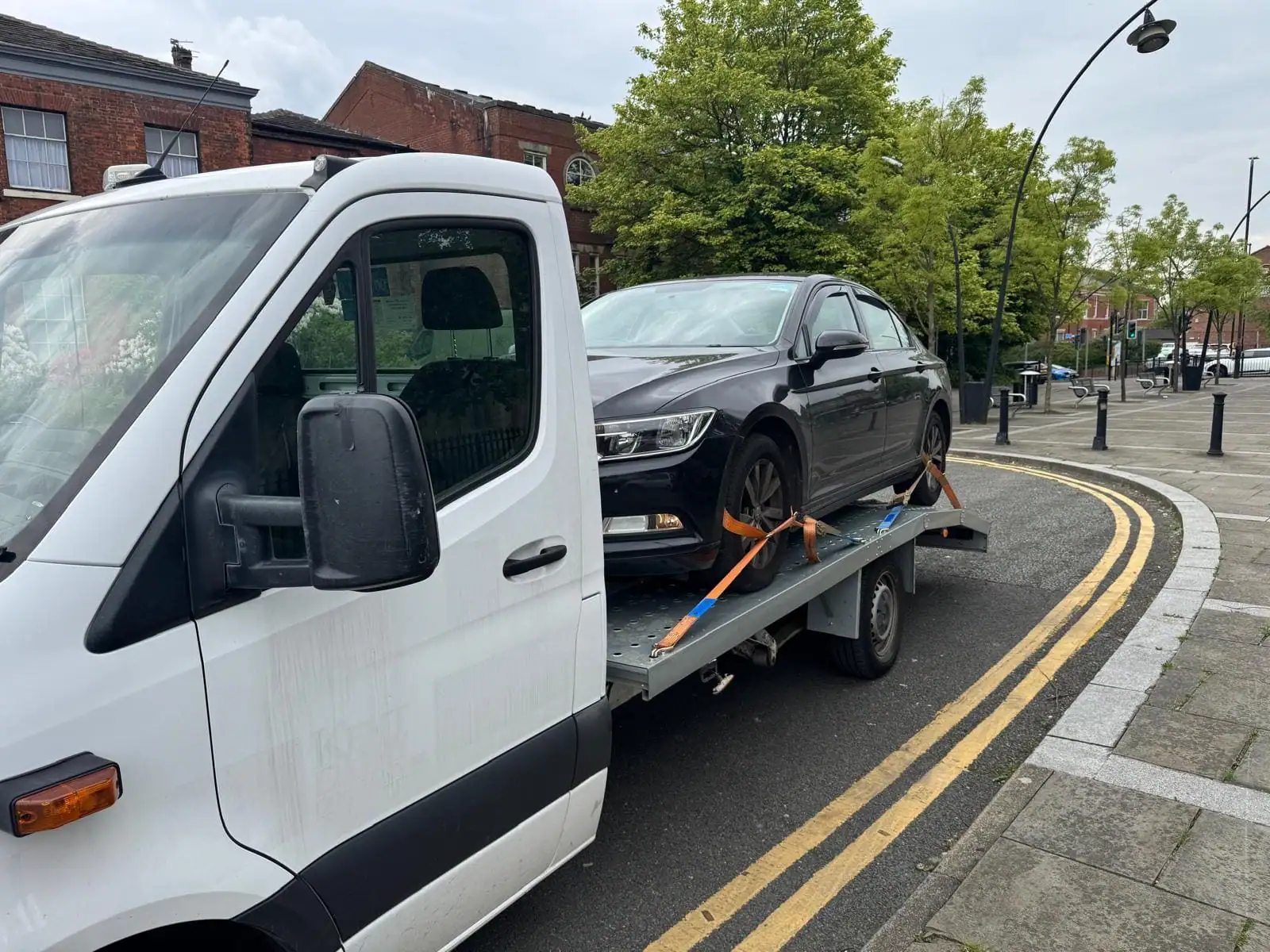 NSY flatbed loading a black saloon on a Sheffield street